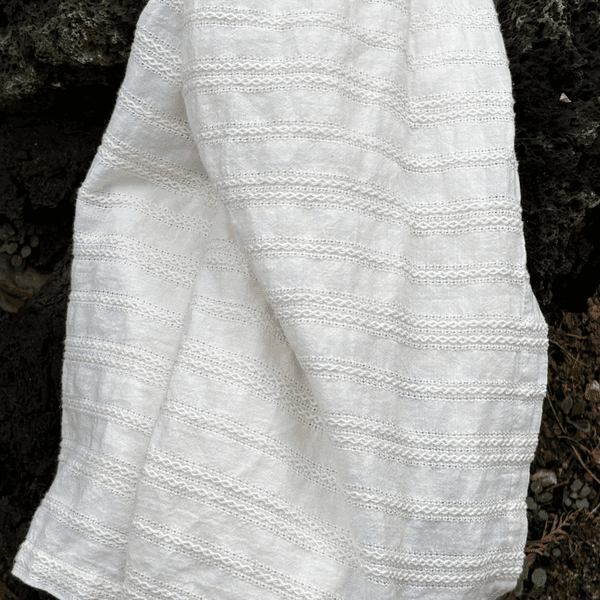 Baby resting comfortably under a dánda wave blanket