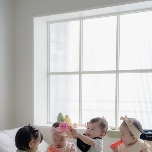 Children playing happily on a soft nursery bed
